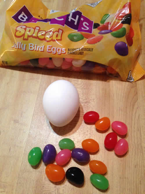 Brach's Spiced Jelly Bird Eggs on a table with a whole chicken egg for shape comparison