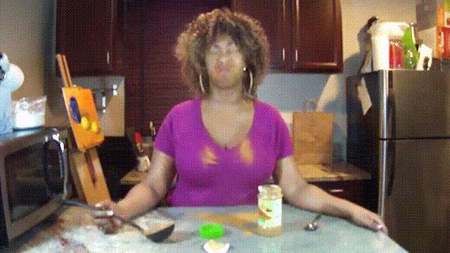 A woman attempting the cinnamon challenge fails, spitting a huge cloud of cinnamon at the camera