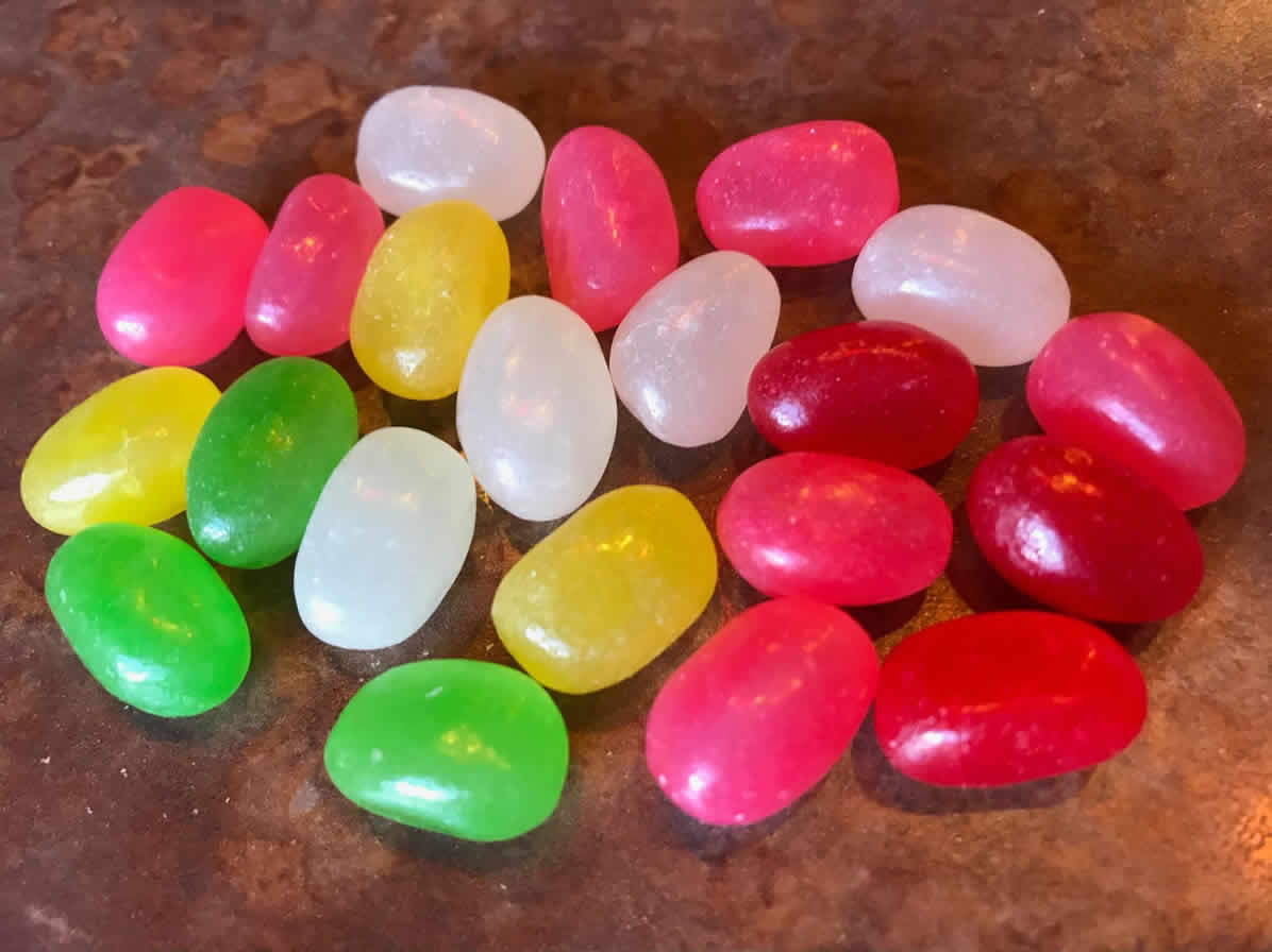 A handful of Just Born spice-flavored jelly beans on a table